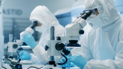 two-engineers-scientists-technicians-in-sterile-cleanroom-suits-use-microscopes-for-component-adjustment-and-research-they-work-in-an-electronic-components-manufacturing-factory