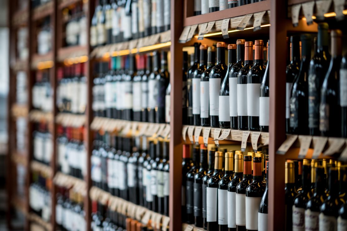 close-up-of-wine-bottles-on-a-shelf-at-a-winery