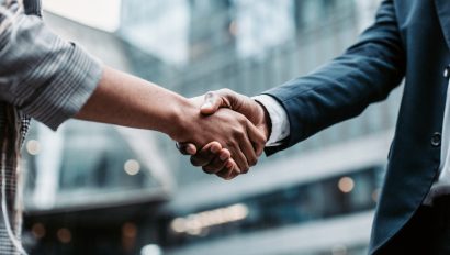 meeting-success-two-business-persons-shaking-hands-standing-outside