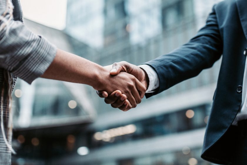 meeting-success-two-business-persons-shaking-hands-standing-outside