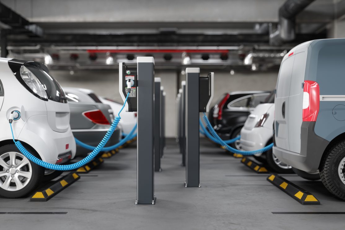 side-view-of-charging-electric-cars-in-parking-garage-clean-energy-concept