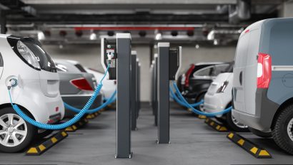 side-view-of-charging-electric-cars-in-parking-garage-clean-energy-concept