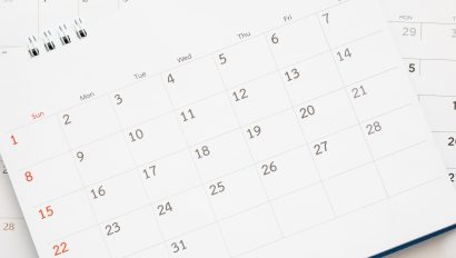 calendar-page-close-up-on-blue-background-business-planning-appointment-meeting-concept