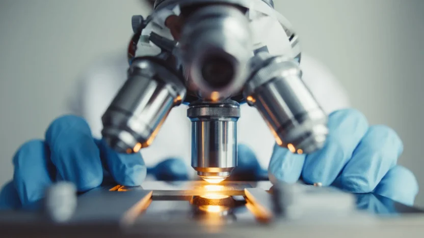 Close up of examining of test sample under the microscope