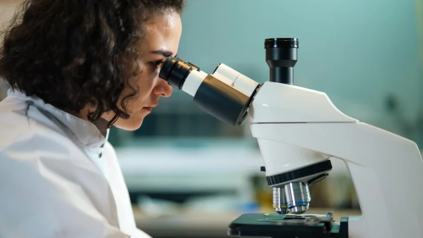 A Woman Looking at a Microscope